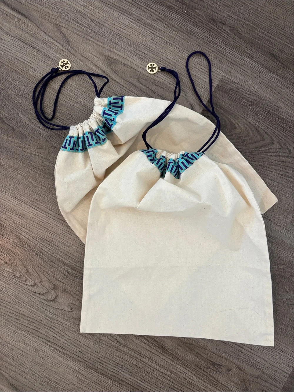 Set of 2 Tory Burch drawstring dust bags, canvas with gold charm